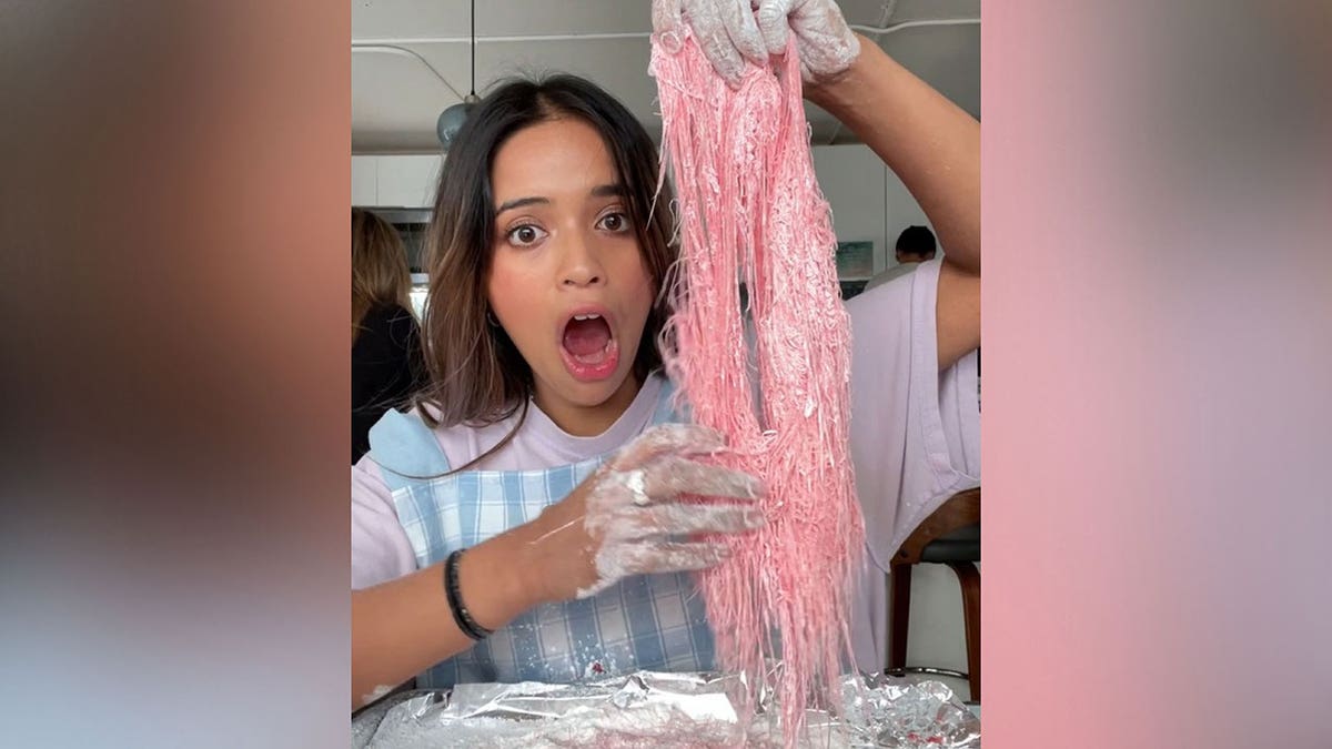 Woman holds homeade dragon's beard candy