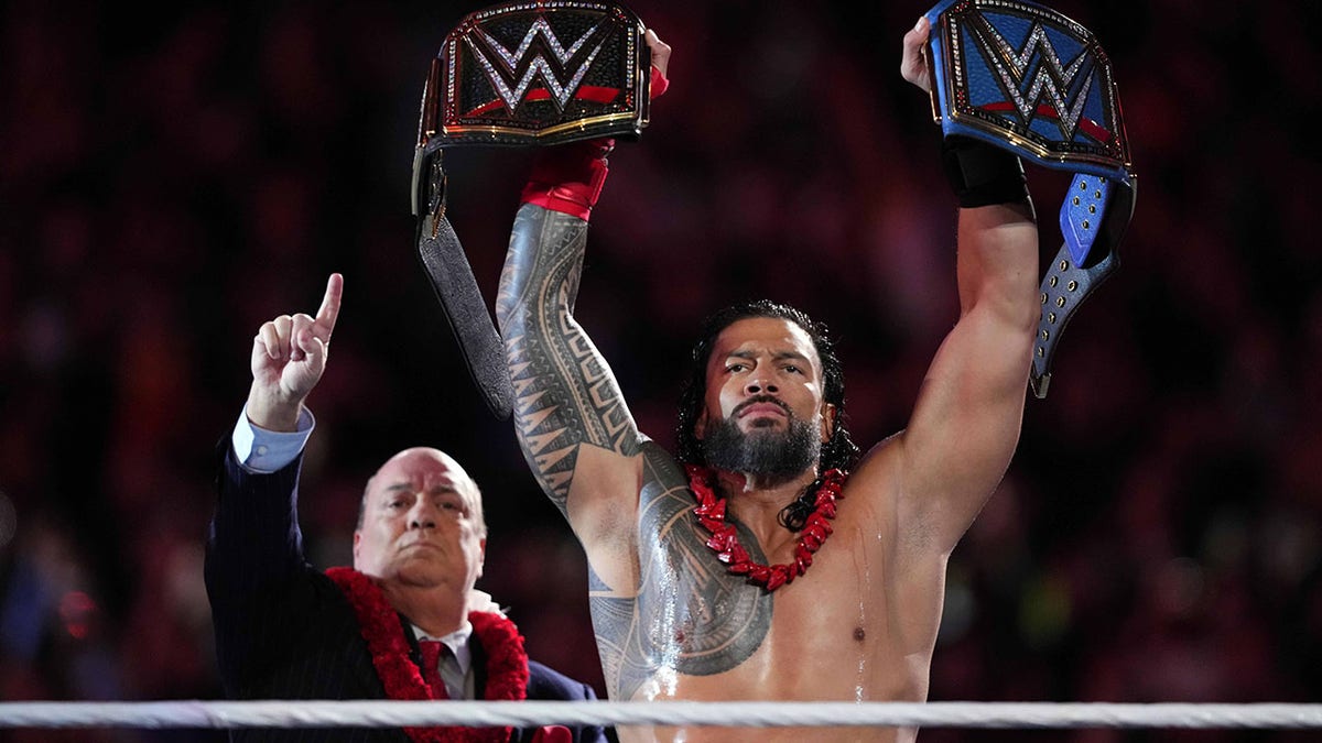 Roman Reigns holds the belts