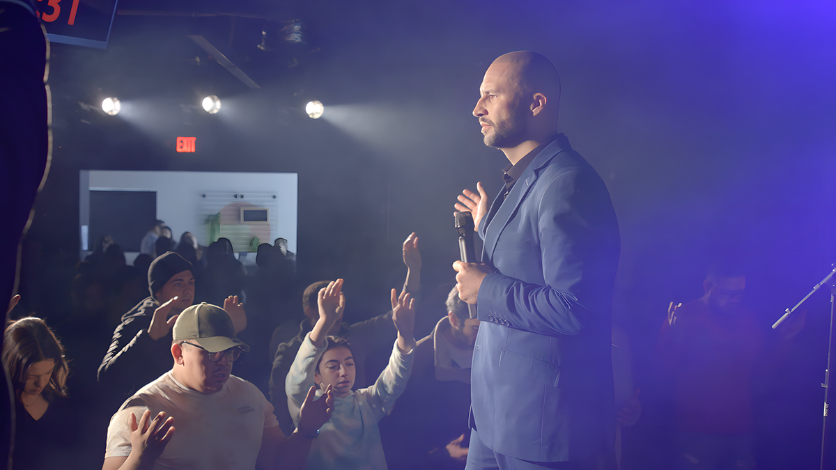 Pastor Mike Signorelli with microphone