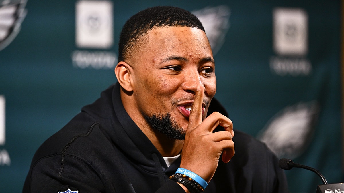 Philadelphia Eagles running back Saquon Barkley gestures during a press conference after signing with the team.