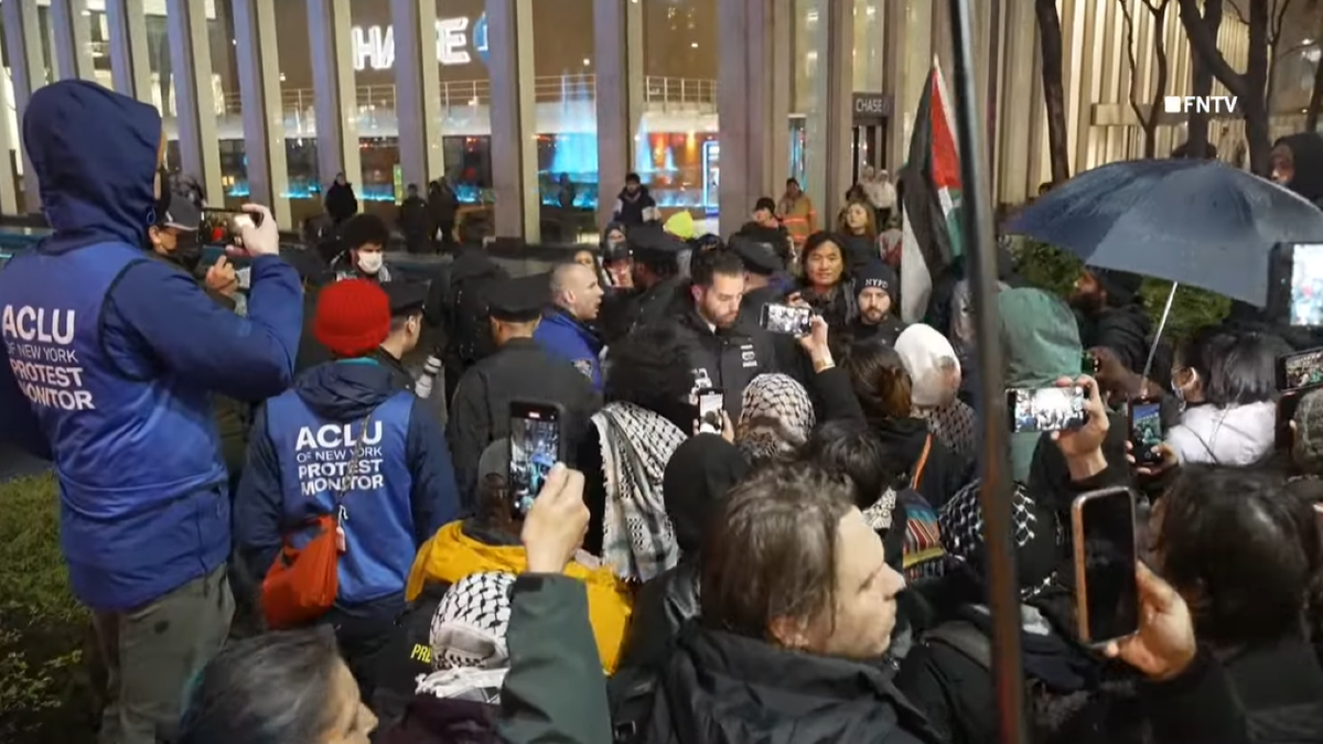 Protestors holding Palestinian flag