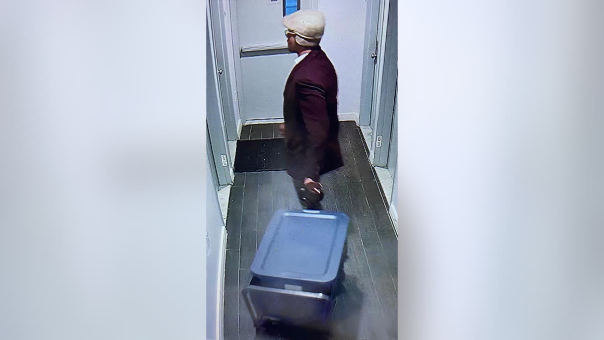 Sheldon Johnson in the hallway of the apartment building where Colin Small's torso was later found
