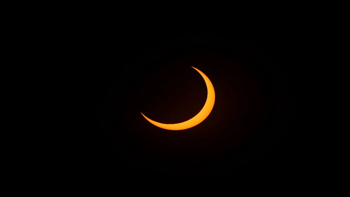 A partial solar eclipse is seen in San Salvador