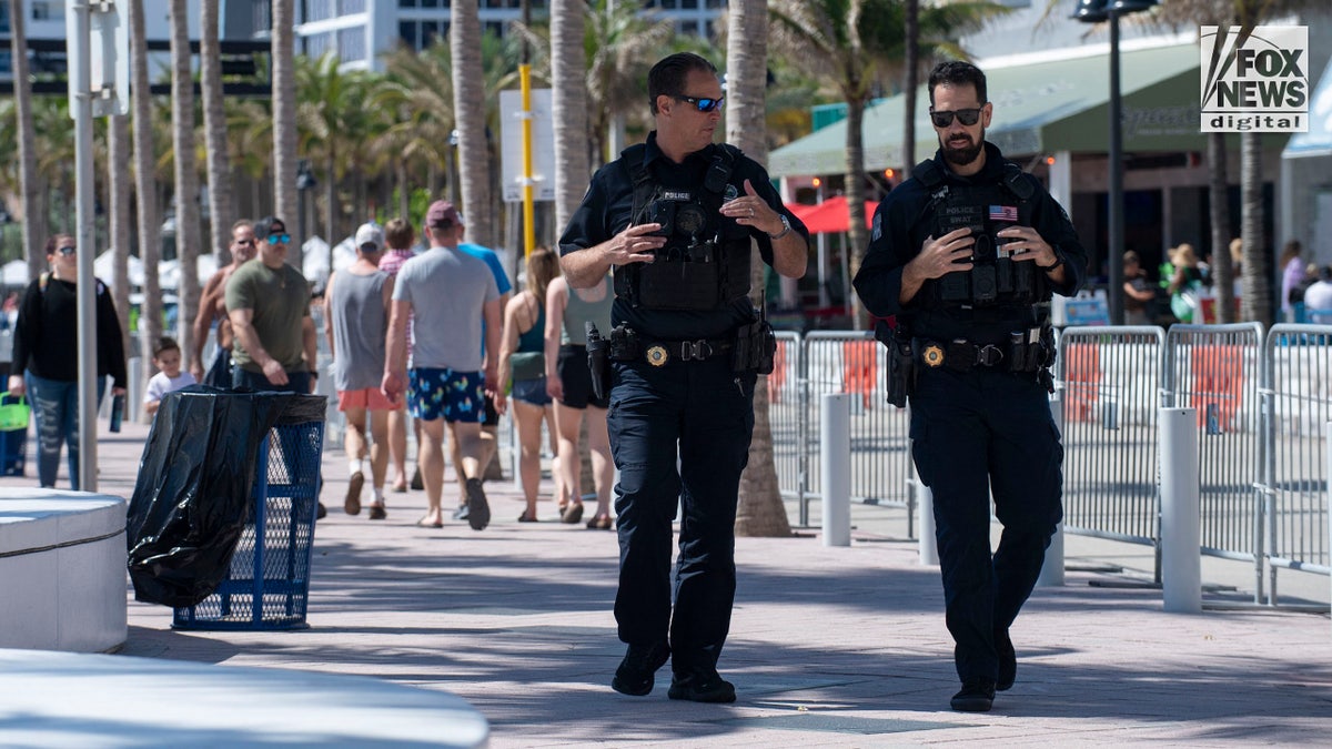 Local police officers patrol as spring breakers enjoy the beach in Fort Lauderdale