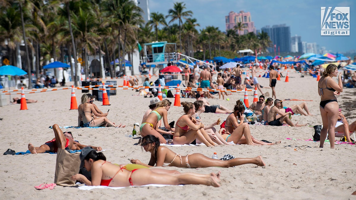 Spring breakers enjoy the sun and sand on Fort Lauderdale Beach