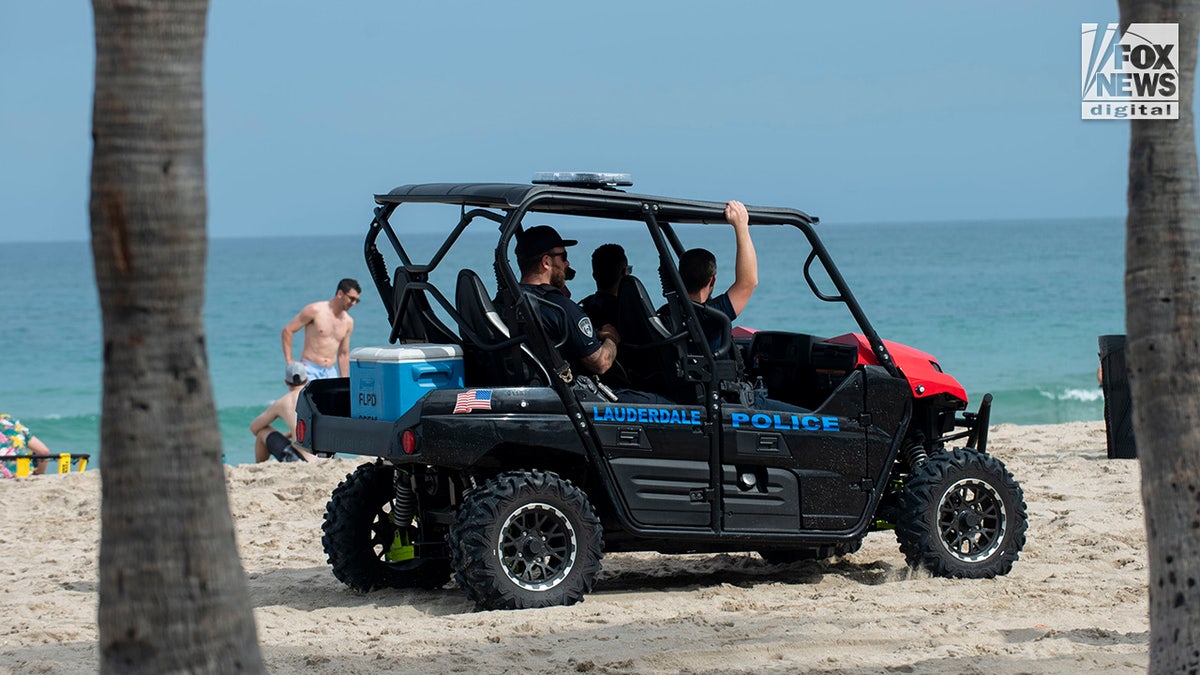 Local police officers patrol as spring breakers enjoy the beach in Fort Lauderdale, Florida