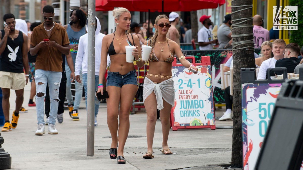 Spring breakers walk along Fort Lauderdale Beach