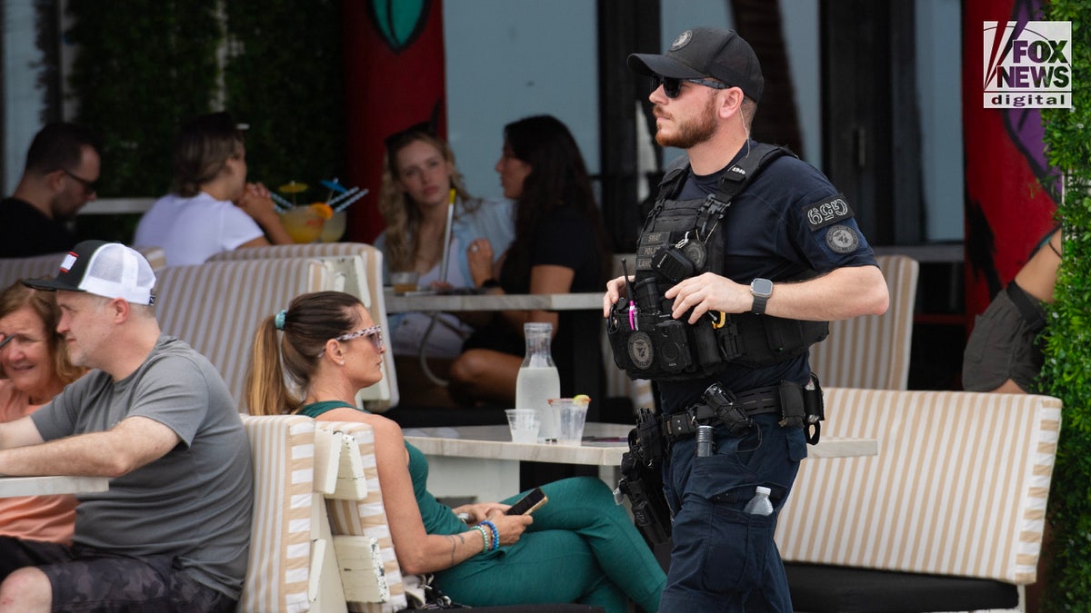 A local police officer patrols the local bar area as spring breakers enjoy the beach in Fort Lauderdale