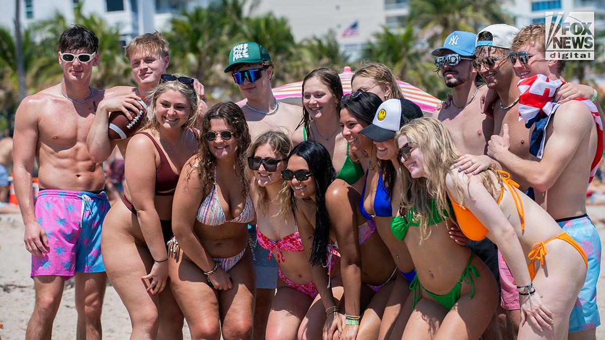A group of spring breakers pose for a photo while enjoying Fort Lauderdale Beach
