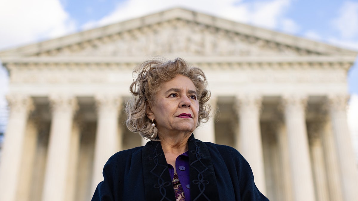 Sylvia Gonzalez stands in front of Supreme Court of the United States