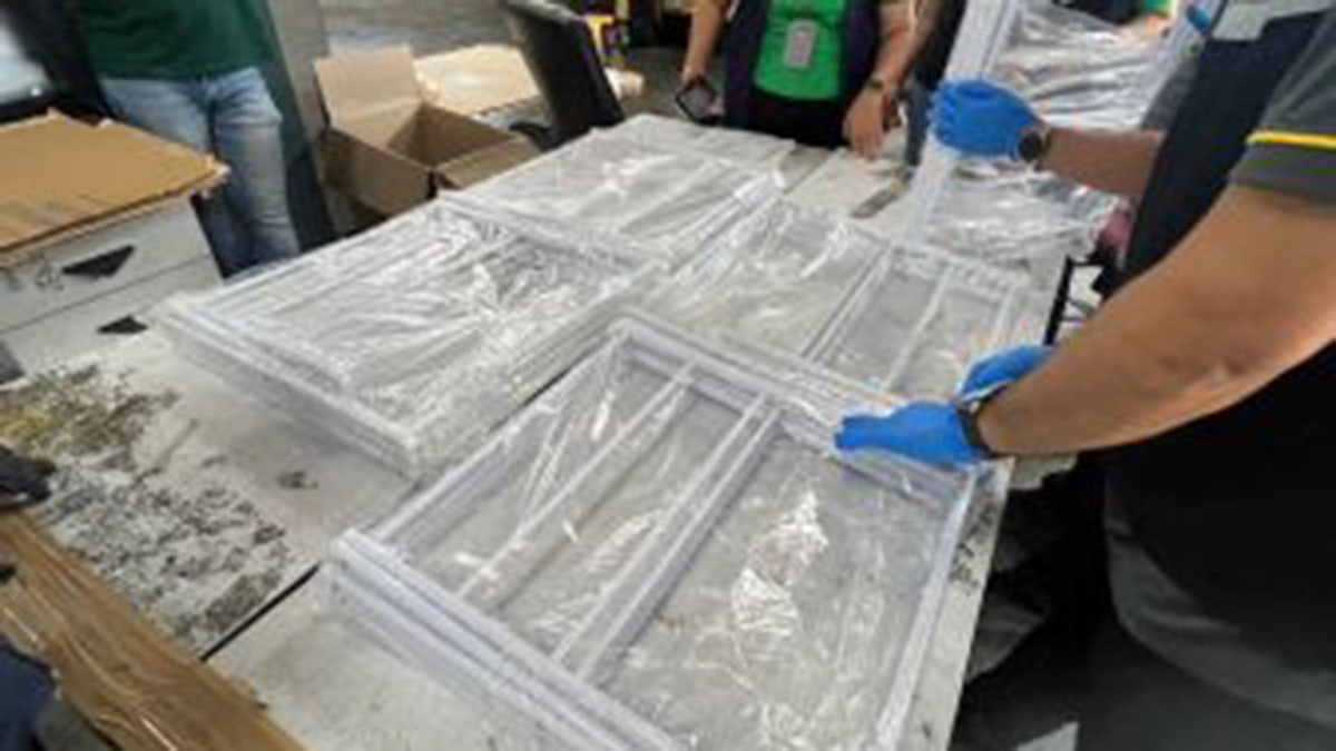 Clothes racks in plastic wrapping on table