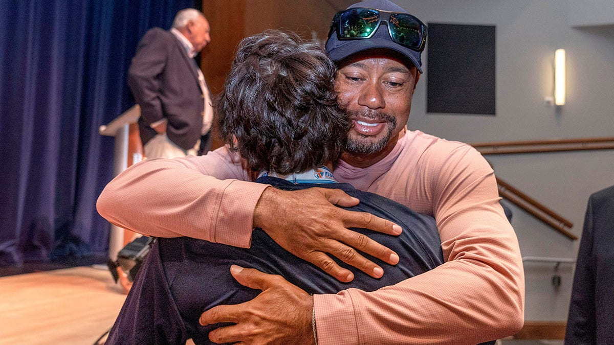 Tiger Woods hugs Charlie