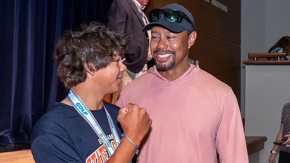 Tiger Woods looks lovingly at Charlie Woods