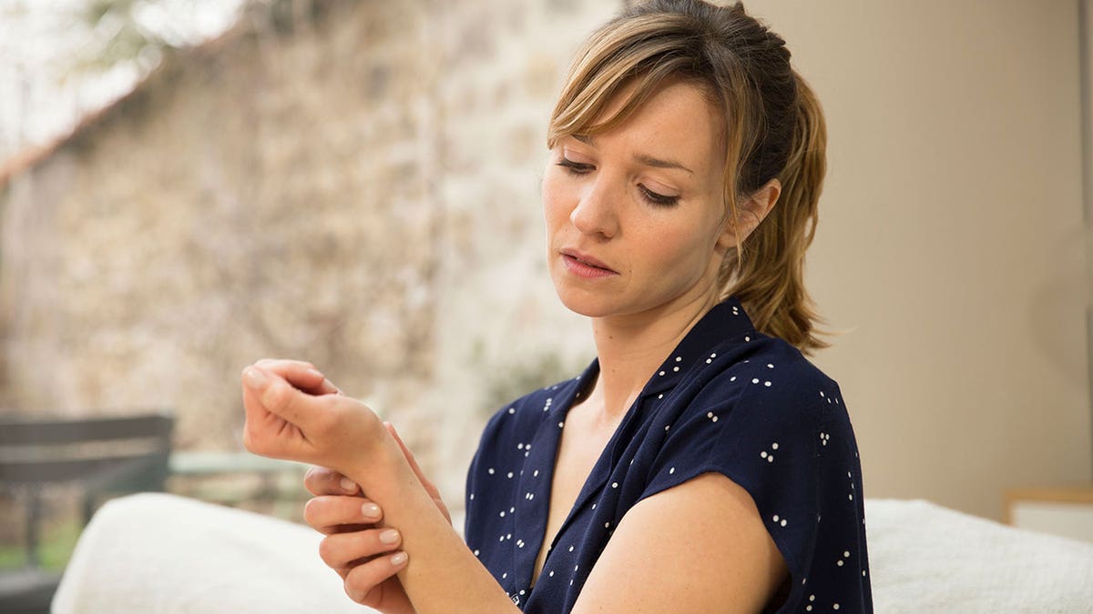 Woman holding her wrist