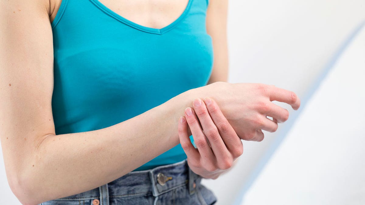 Woman holding her wrist