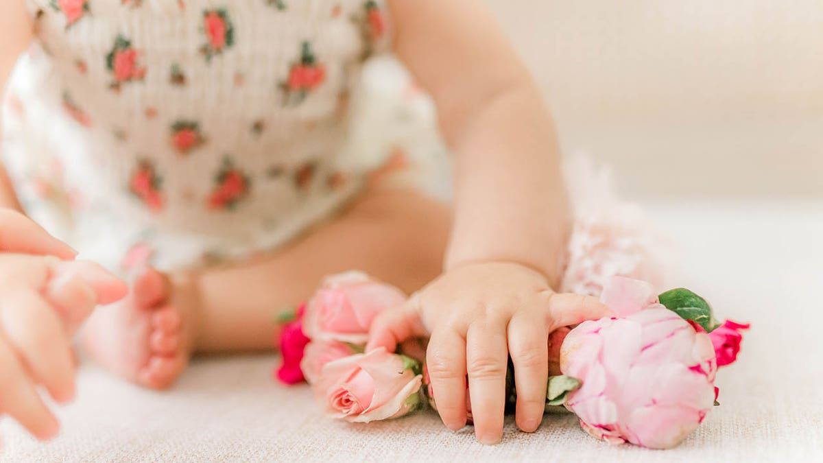 baby woman pinch flowers