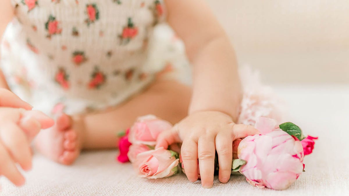 baby girl with flowers