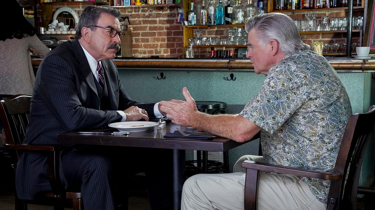 Tom Selleck and Treat Williams chat in a coffee shop on Blue Bloods