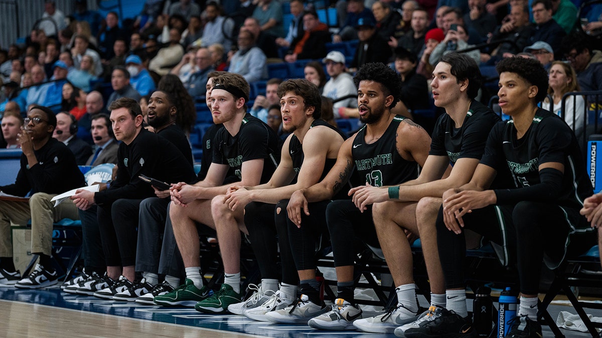 Dartmouth players sit on the team bench