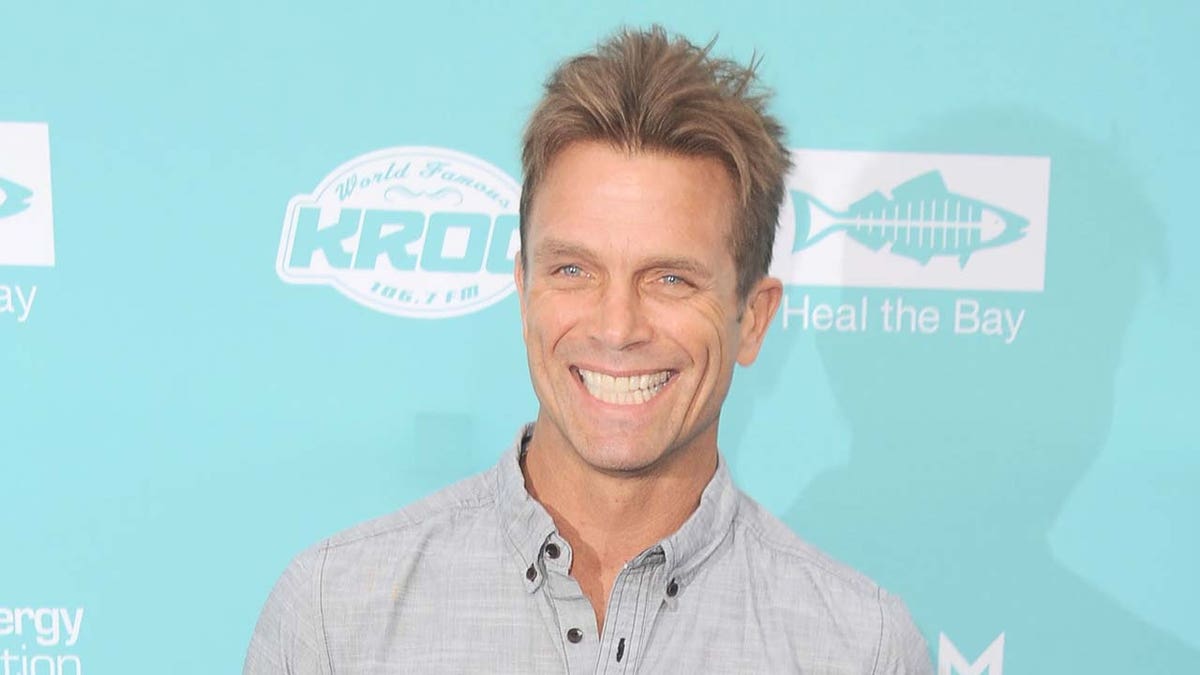 Actor David Chokachi stands in front of blue backdrop
