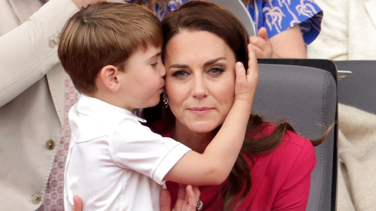 Prince Louis cradling his mothers face