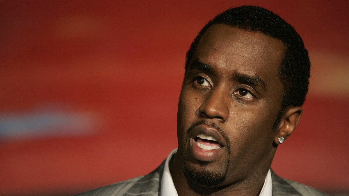 Sean Combs sits successful beforehand of reddish backdrop