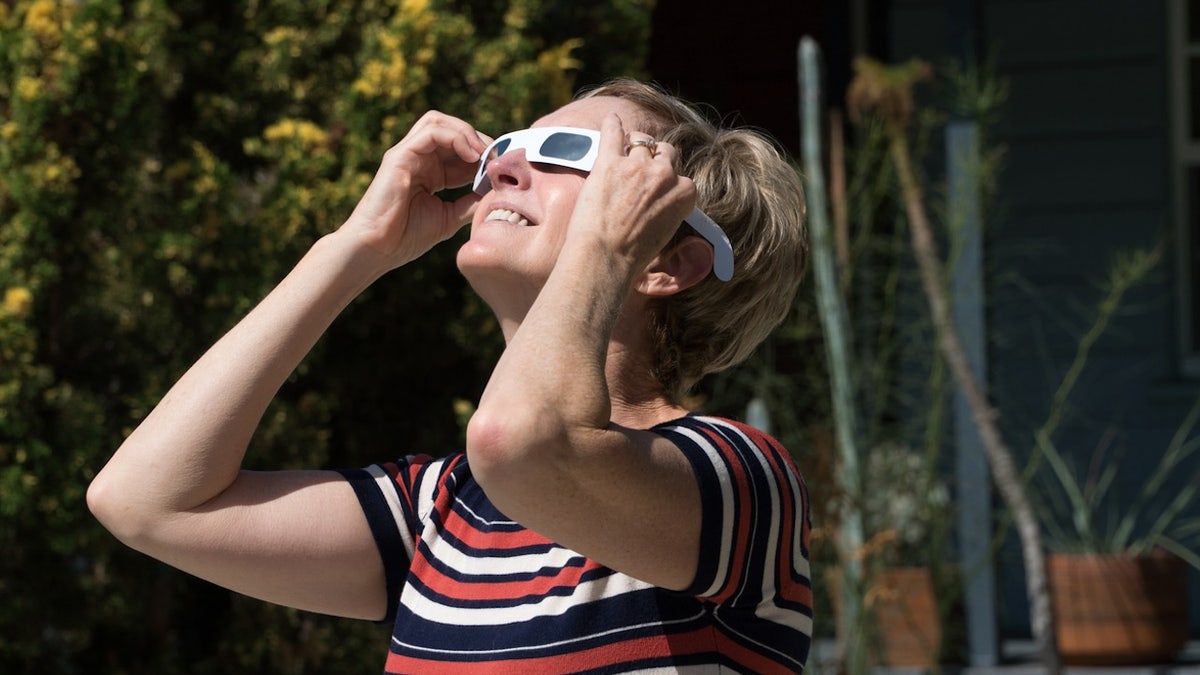 A woman views an eclipse