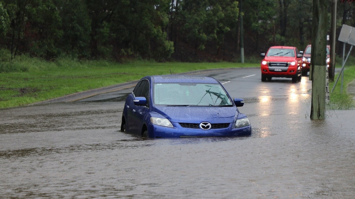 Car flooded successful street