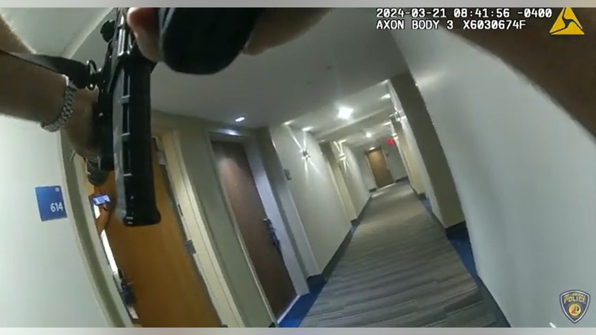 Bodycam from the injured officer shows the suspect (in slow motion) opening the hotel room door.