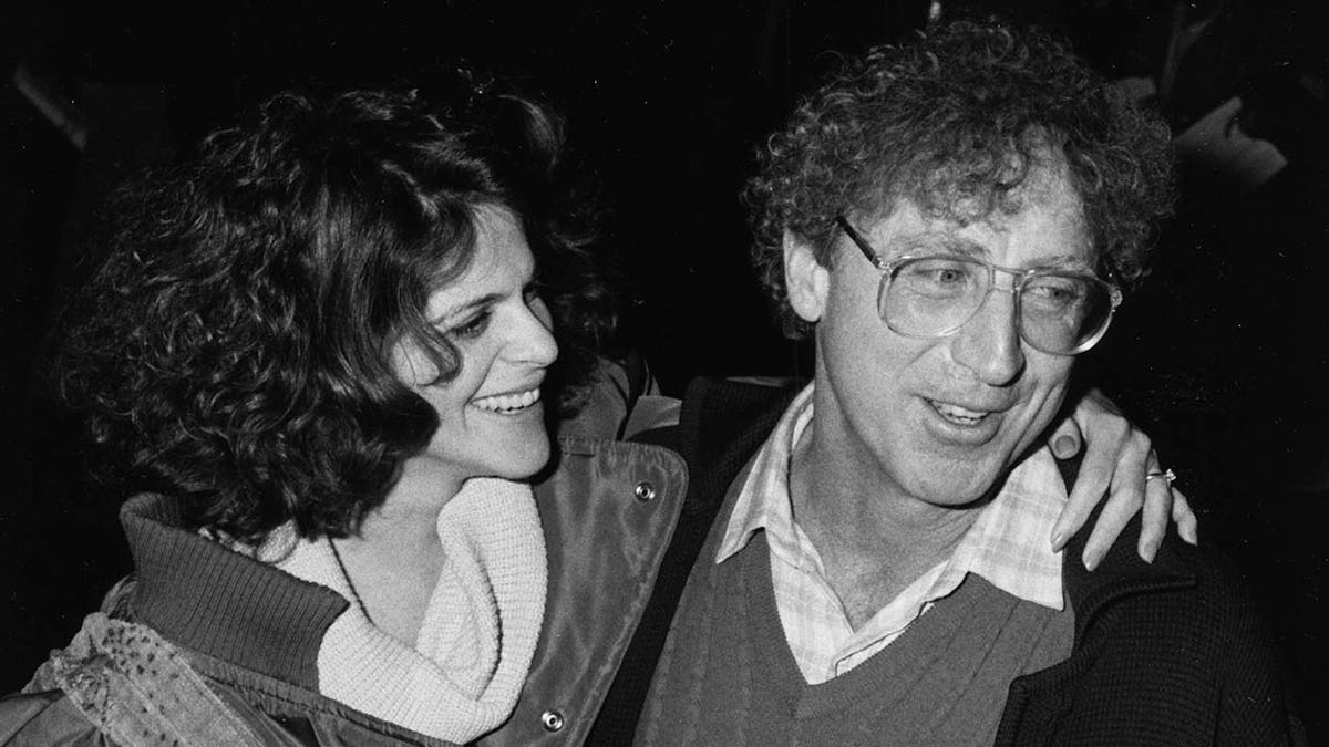 Comedian Gilda Radner and Gene Wilder smile outside of studio in New York
