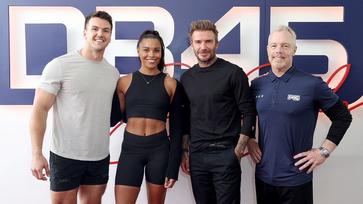 Gunnar Peterson in navy blue poses with David Beckham, Cory George and Morgan Mitchell for the F45 Training Launch