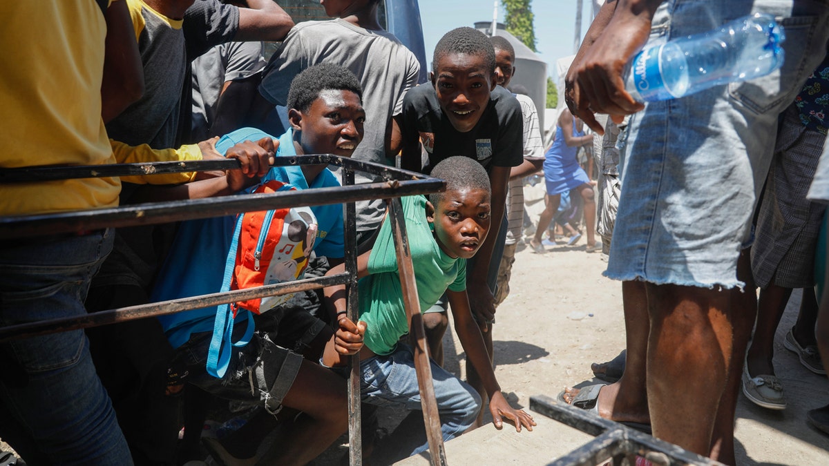 Security concerns complicate council's appointment of interim Haitian leader Children take cover from gunshots in Haiti