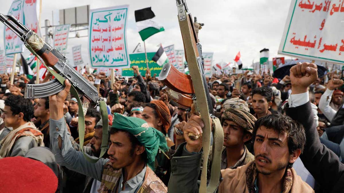 Houthis supporters waving guns in the air