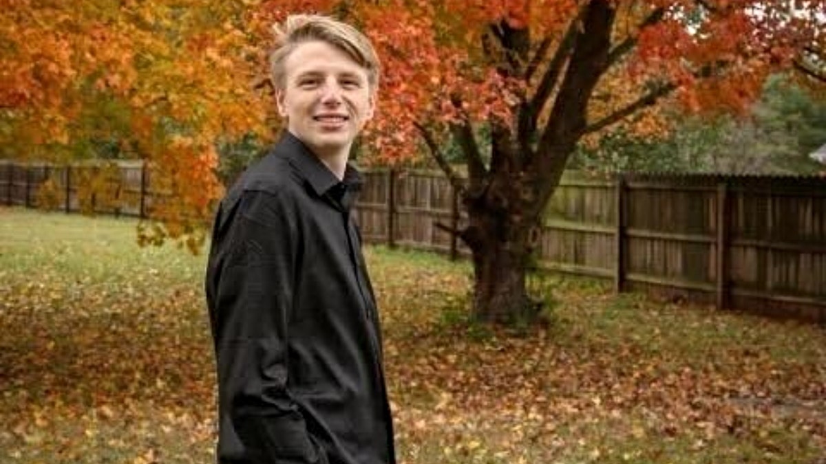 Riley Strain photographed with foliage in the background