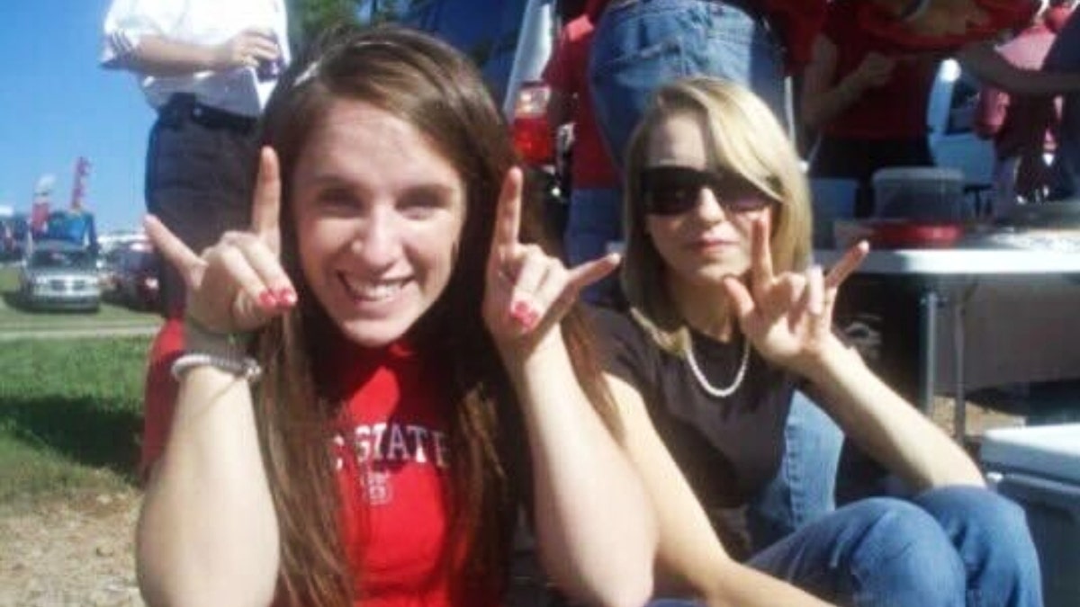 Christie Lewis (left) poses in an NC State shirt next to her friend while attending the university