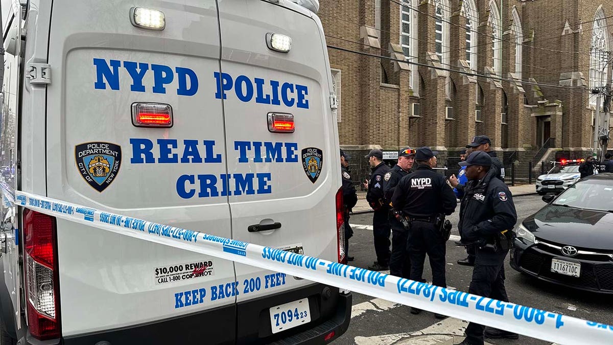 Police truck with officers standing nearby 