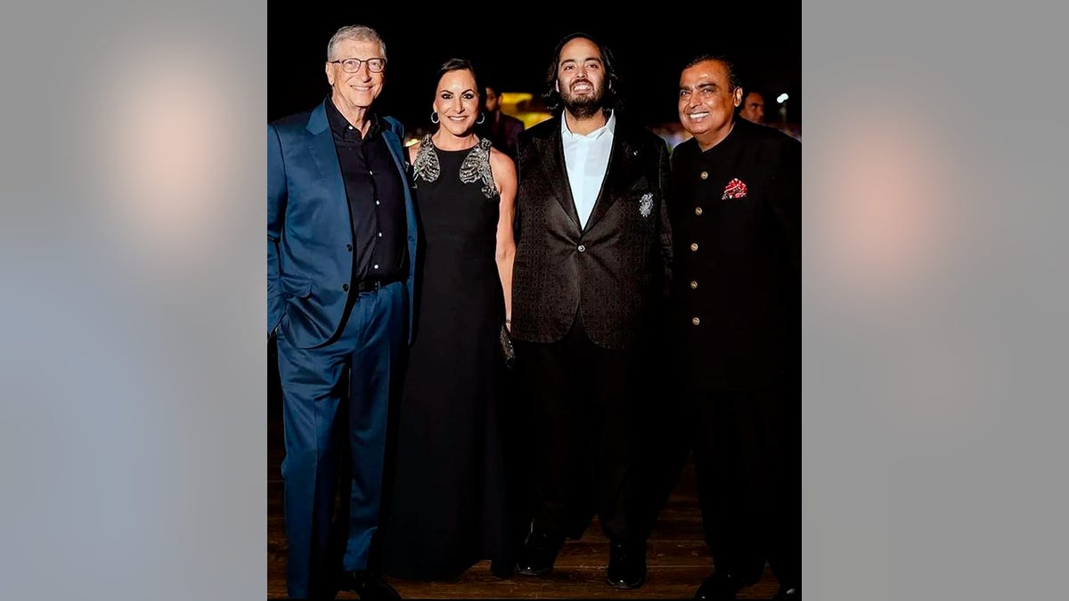 Bill Gates in a blue suit poses with girlfriend Paula Hurd and Anant and Mukesh Ambani at the pre-wedding festivities for Anant