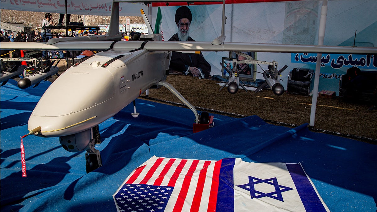 drone with US, Israel flags on blue tarp in Tehran