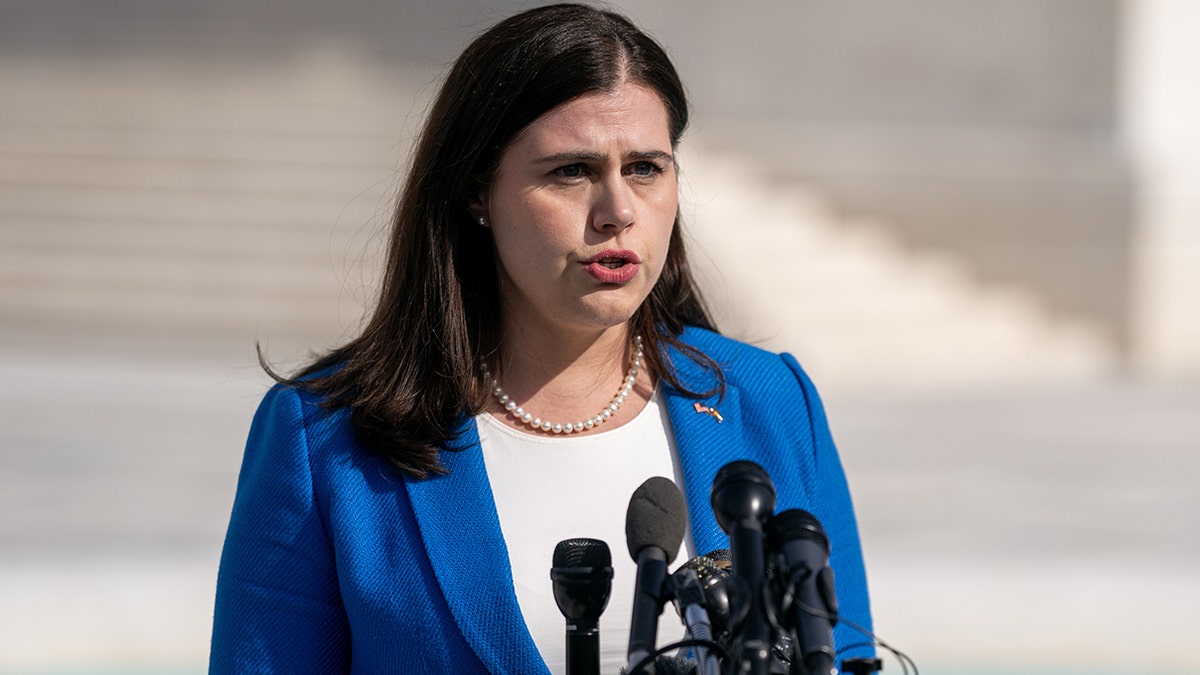 Colorado Secretary of State Jena Griswold speaks into microphones