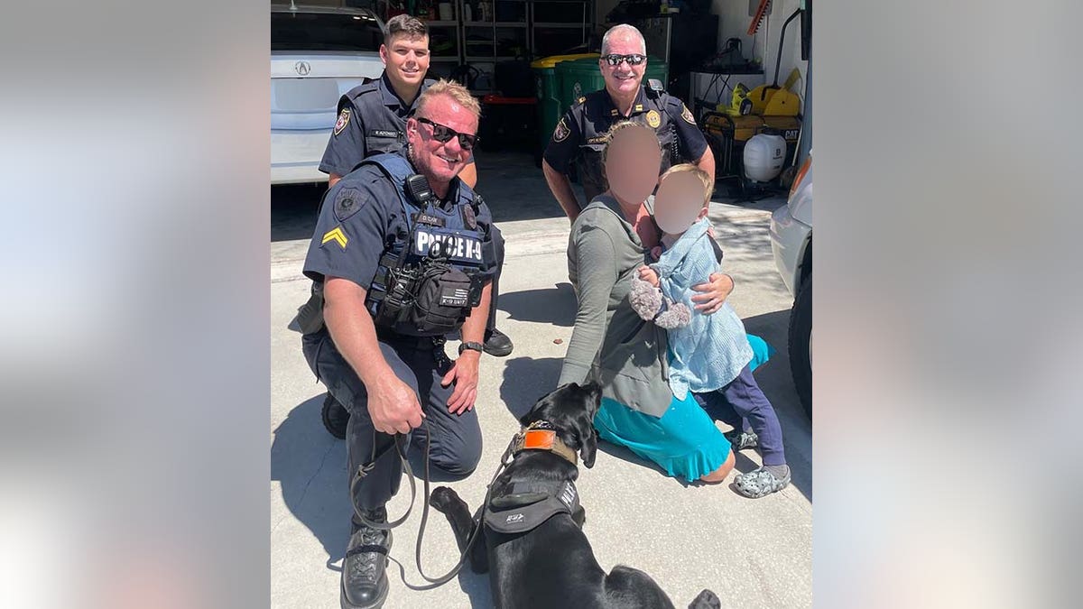 K-9 Midnight and Clark pose with the boy and his mom