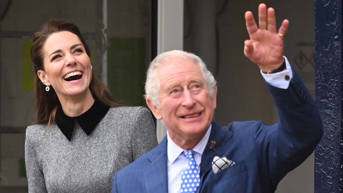 Kate Middleton wears a gray suit alongside King Charles in a blue suit.