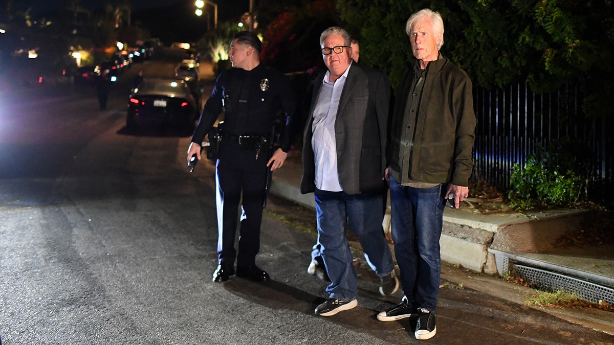 Keith Morrison stands outside Matthew Perry's house with another few men and police 