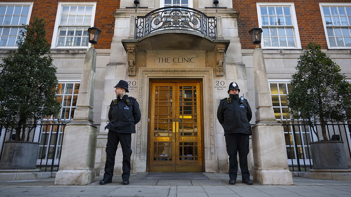 Police guards stand outside the London Clinic after Kate Middleton underwent surgery