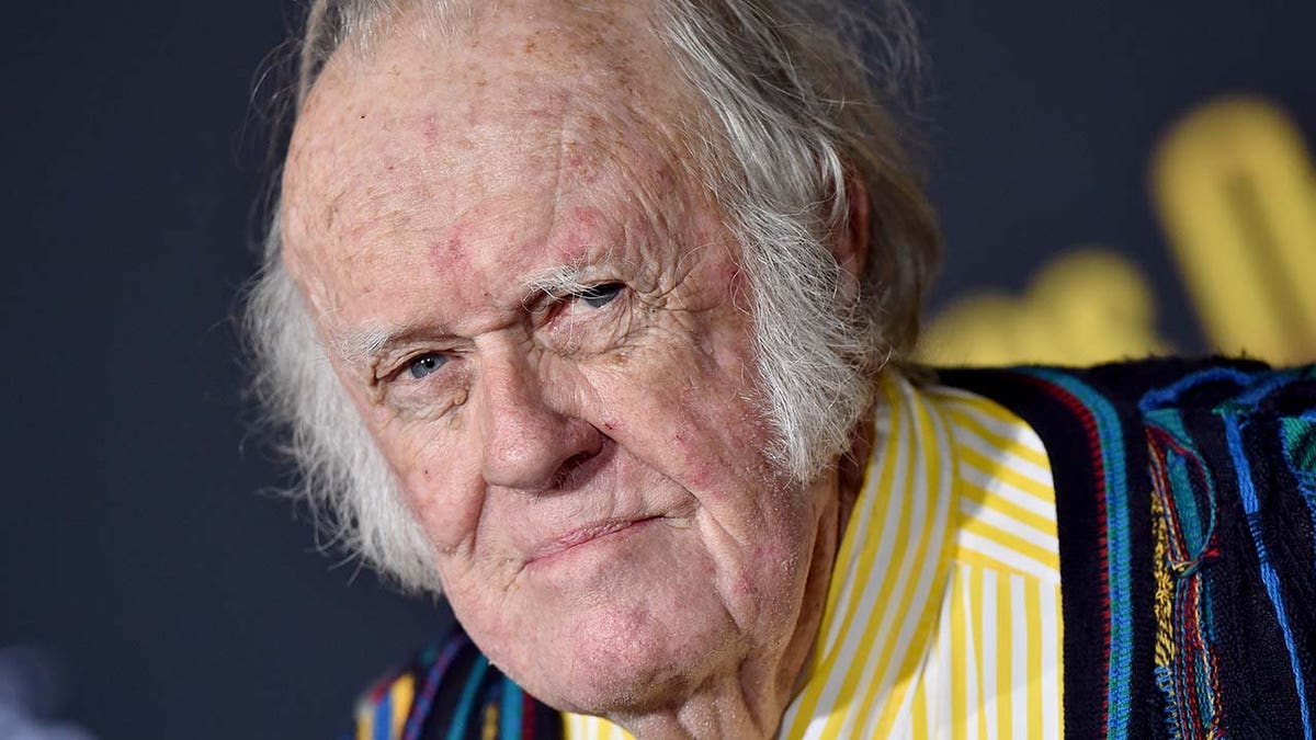 M. Emmet Walsh wears yellow striped shirt at film premiere in Hollywood.