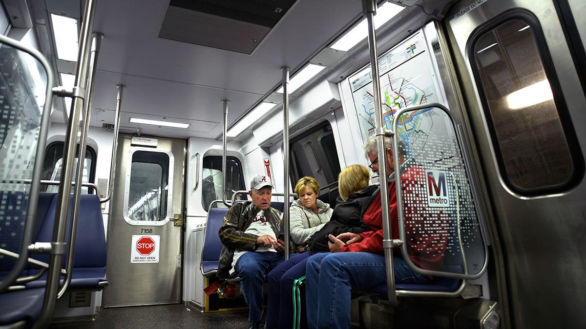 Toursists sit on Metro train in Washington DC