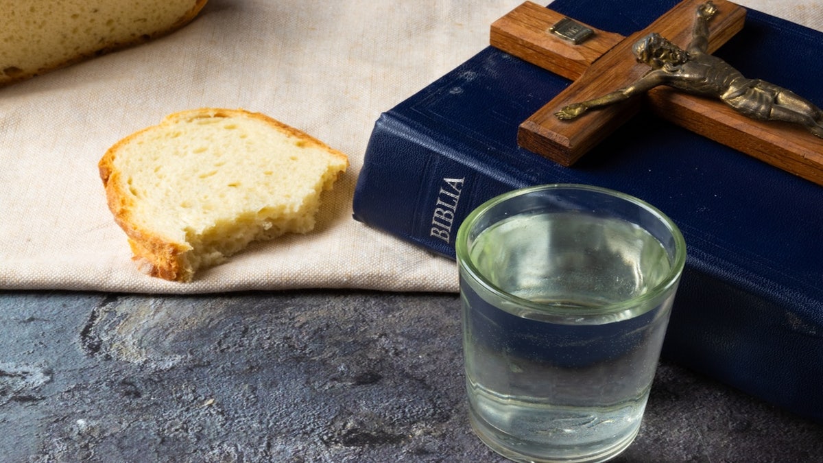 Lent - holy bible, crucifix, water and bread