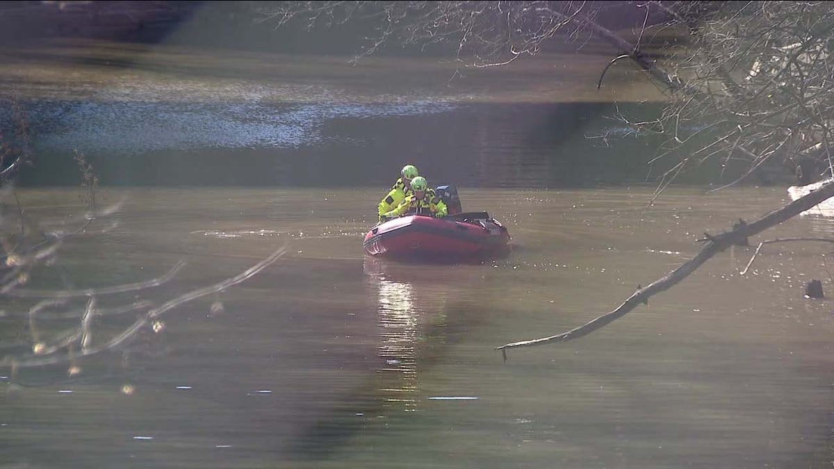 rescuers searching in creek