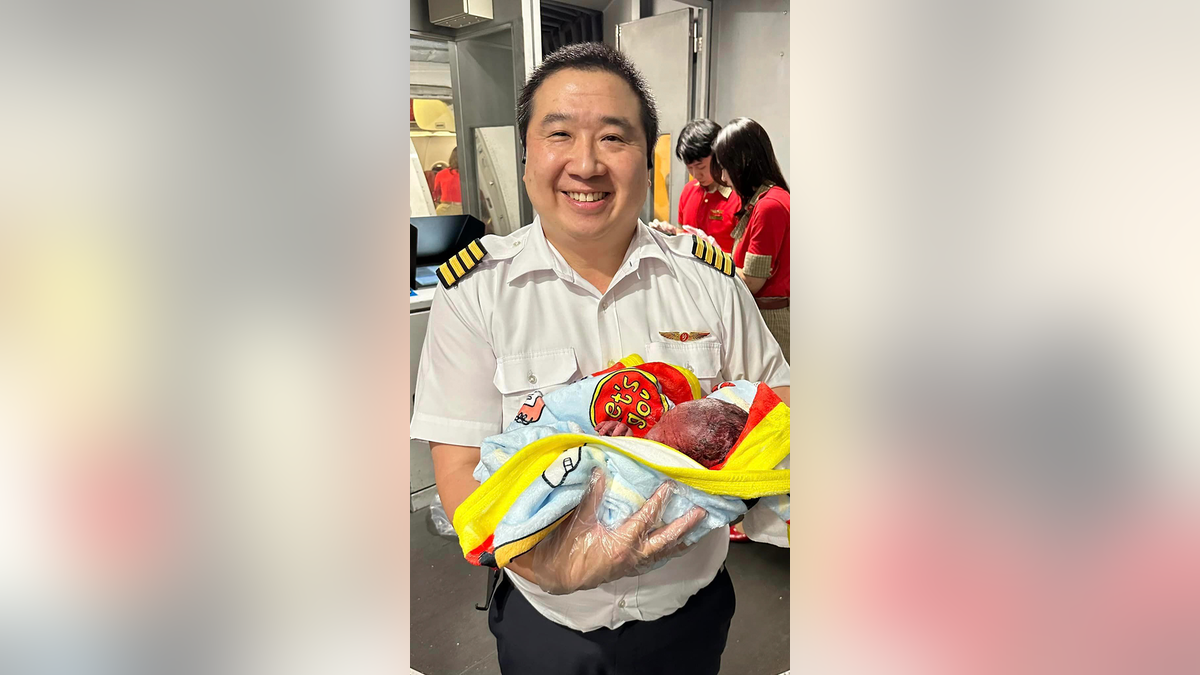 Pilot holding baby