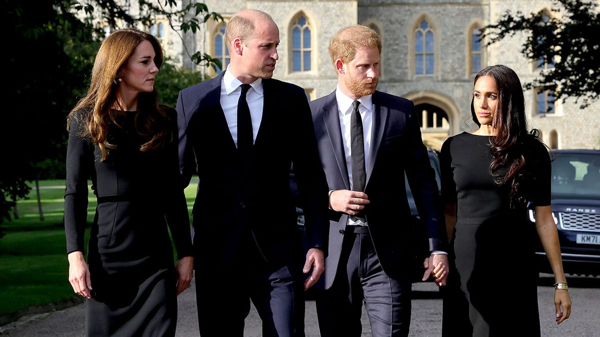 Kate Middleton walks with Prince William and Prince Harry and Meghan Markle after the Queen passes away outside Windsor Castle