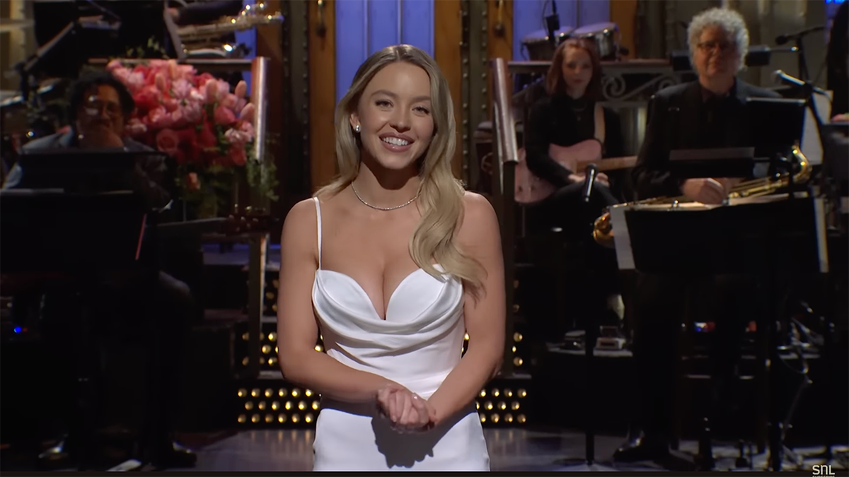 Sydney Sweeney shows a lot of cleavage in a white plunging dress as host on "SNL"